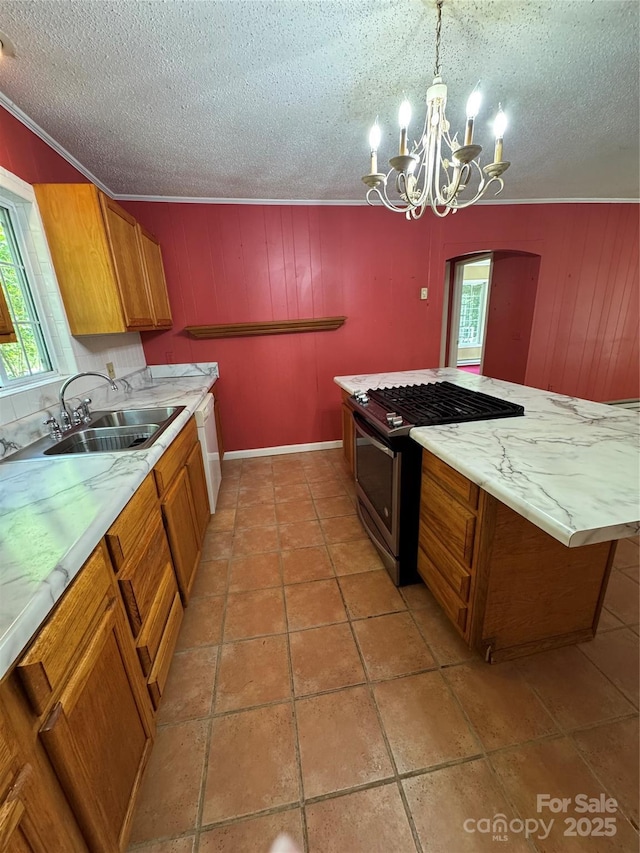 232 Cole Hollow Rd, Newland, NC 28657 - kitchen with brown cabinetry, gas stove, ornamental molding, a chandelier, and a textured ceiling