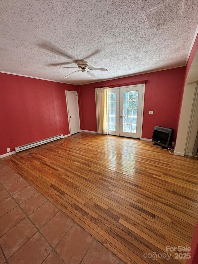 232 Cole Hollow Rd, Newland, NC 28657 - empty room featuring a baseboard radiator, heating unit, wood-type flooring, ceiling fan, and a textured ceiling