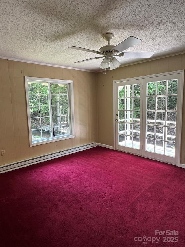 232 Cole Hollow Rd, Newland, NC 28657 - carpeted spare room featuring a textured ceiling, plenty of natural light, a baseboard heating unit, and a ceiling fan