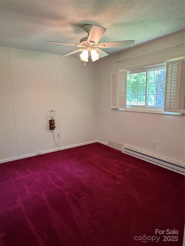 232 Cole Hollow Rd, Newland, NC 28657 - spare room featuring a baseboard heating unit, carpet, a textured ceiling, and a ceiling fan