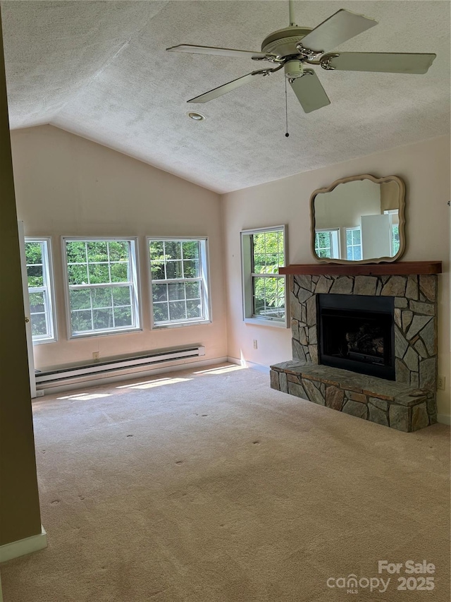232 Cole Hollow Rd, Newland, NC 28657 - unfurnished living room with carpet flooring, a baseboard heating unit, a textured ceiling, vaulted ceiling, and a fireplace