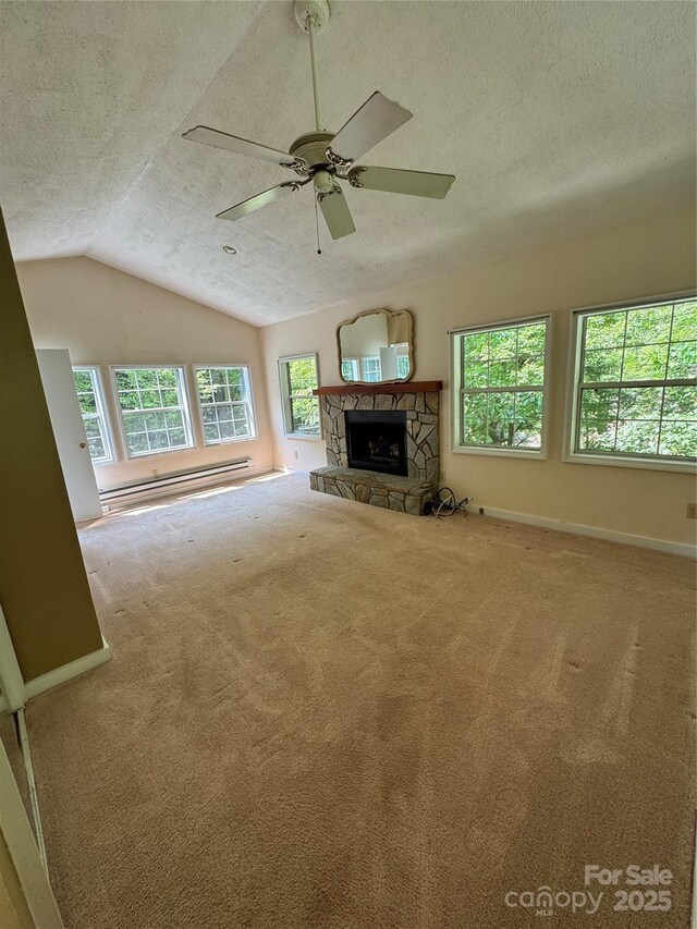 232 Cole Hollow Rd, Newland, NC 28657 - unfurnished living room with a textured ceiling, plenty of natural light, lofted ceiling, a baseboard radiator, and carpet