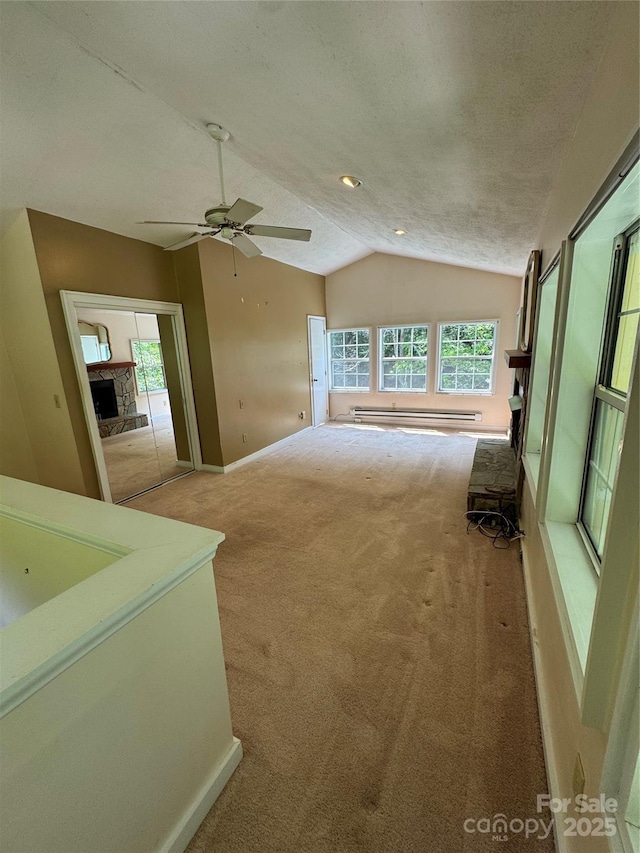 232 Cole Hollow Rd, Newland, NC 28657 - unfurnished living room with carpet floors, a baseboard heating unit, vaulted ceiling, and ceiling fan