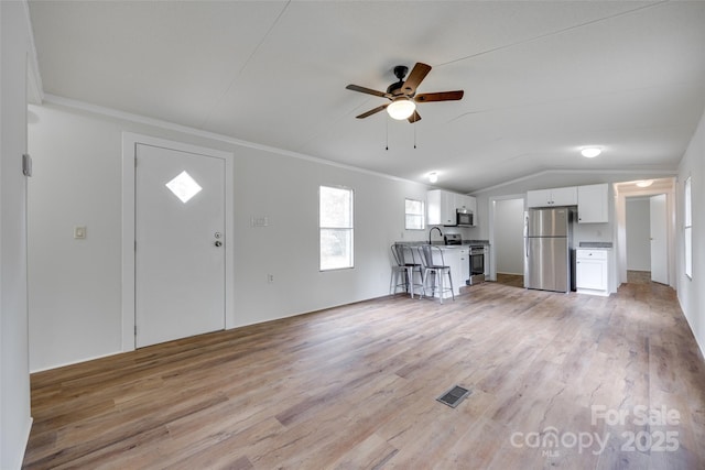 976 Neely Store Rd, Rock Hill, SC 29730 - unfurnished living room with a ceiling fan, light wood finished floors, ornamental molding, vaulted ceiling, and a sink