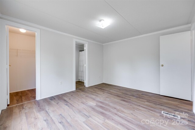 976 Neely Store Rd, Rock Hill, SC 29730 - unfurnished bedroom featuring a spacious closet, wood finished floors, a closet, crown molding, and ensuite bath