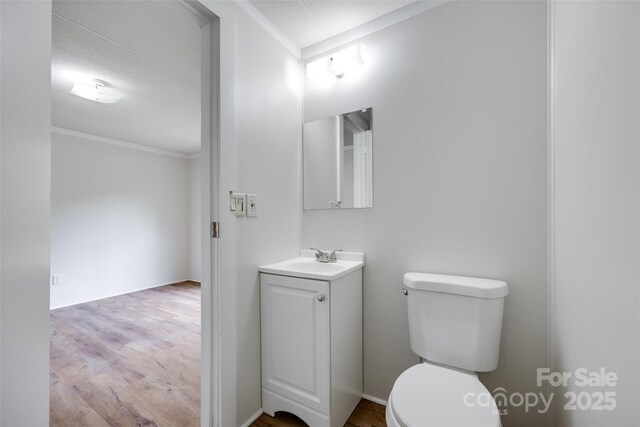976 Neely Store Rd, Rock Hill, SC 29730 - half bath featuring toilet, vanity, crown molding, and wood finished floors