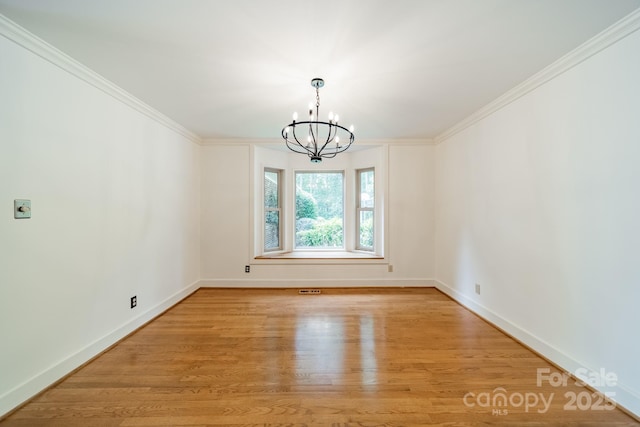 12705 Caldwell Rd, Charlotte, NC 28213 - empty room with a chandelier, light wood finished floors, and ornamental molding