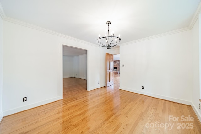 12705 Caldwell Rd, Charlotte, NC 28213 - spare room featuring a chandelier, ornamental molding, and light wood-style floors