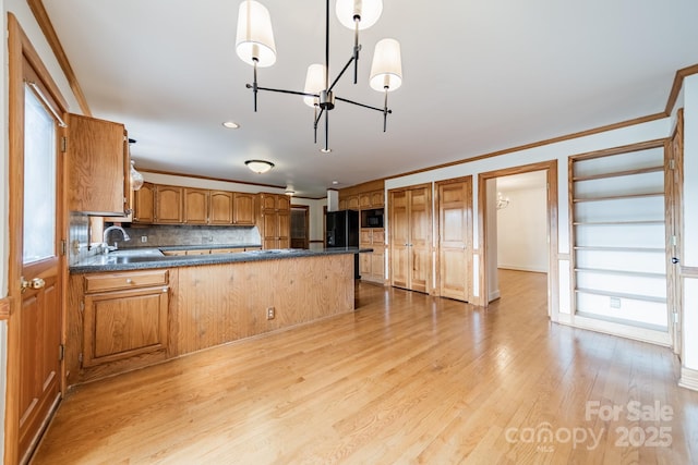 12705 Caldwell Rd, Charlotte, NC 28213 - kitchen with dark countertops, black appliances, a chandelier, tasteful backsplash, and a peninsula