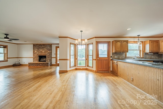 12705 Caldwell Rd, Charlotte, NC 28213 - kitchen with light wood-style floors, backsplash, decorative light fixtures, and ornamental molding