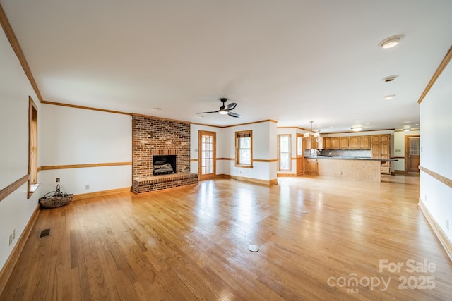 12705 Caldwell Rd, Charlotte, NC 28213 - unfurnished living room featuring a fireplace, ceiling fan, light wood finished floors, ornamental molding, and recessed lighting