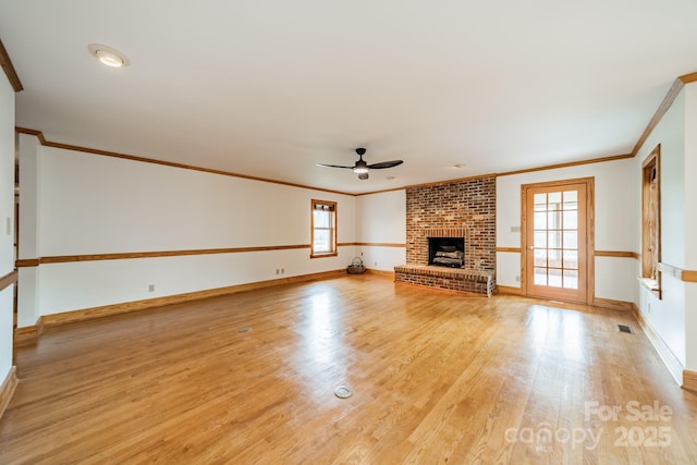 12705 Caldwell Rd, Charlotte, NC 28213 - unfurnished living room with a ceiling fan, light wood-type flooring, ornamental molding, and a brick fireplace
