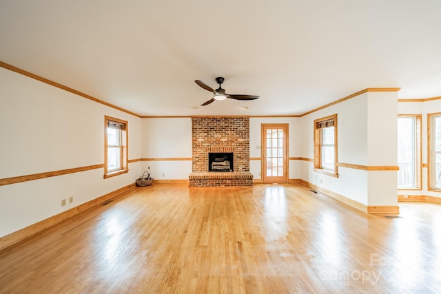 12705 Caldwell Rd, Charlotte, NC 28213 - unfurnished living room with crown molding, a ceiling fan, light wood-type flooring, and a fireplace