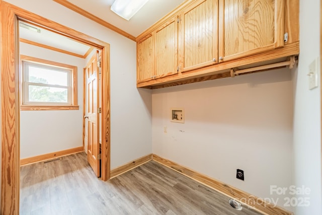 12705 Caldwell Rd, Charlotte, NC 28213 - washroom with cabinet space, ornamental molding, light wood-style flooring, and washer hookup