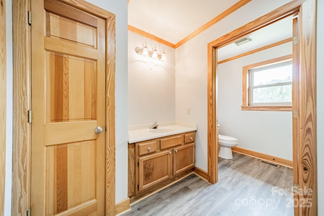 12705 Caldwell Rd, Charlotte, NC 28213 - bathroom featuring vanity, crown molding, and wood finished floors