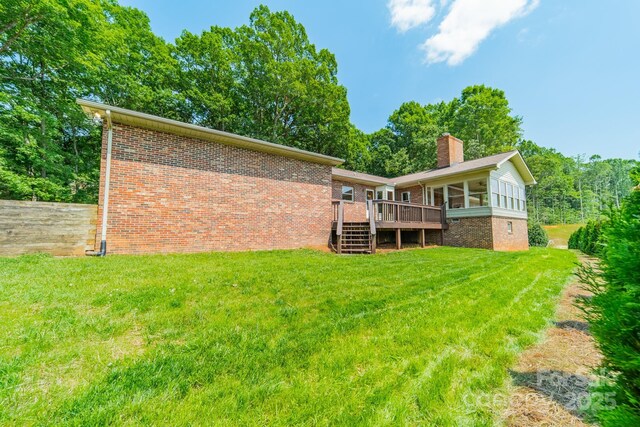 12705 Caldwell Rd, Charlotte, NC 28213 - back of house with a deck, a chimney, a lawn, and brick siding
