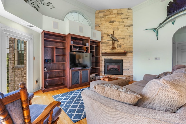 3541 Blankenship Dr, Morganton, NC 28655 - living area featuring wood finished floors, ornamental molding, a fireplace, and arched walkways