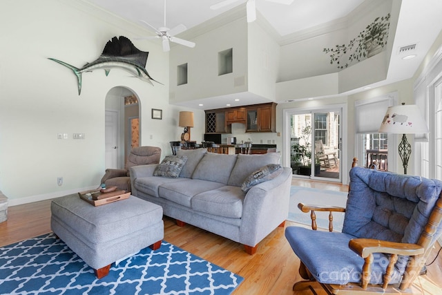 3541 Blankenship Dr, Morganton, NC 28655 - living area with ornamental molding, ceiling fan, arched walkways, light wood finished floors, and a towering ceiling