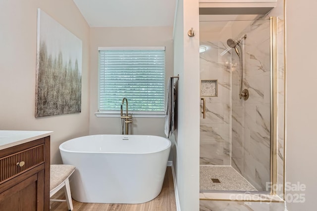 7810 Leisure Ln, Huntersville, NC 28078 - bathroom with a freestanding tub, a marble finish shower, vanity, and wood finished floors
