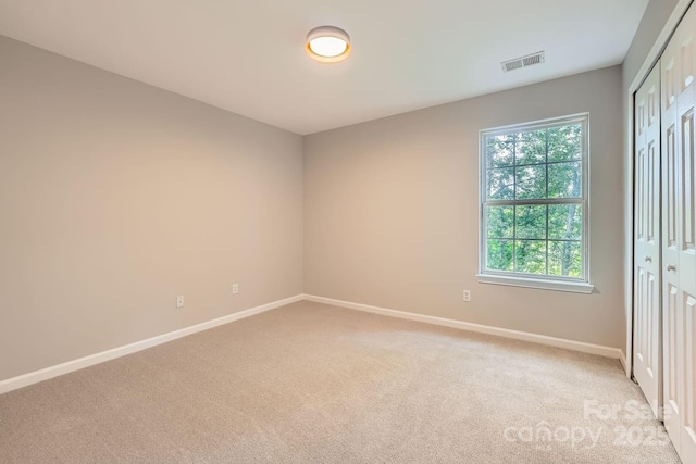 7810 Leisure Ln, Huntersville, NC 28078 - unfurnished bedroom with light carpet, multiple windows, and a closet