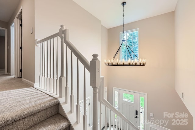 7810 Leisure Ln, Huntersville, NC 28078 - staircase featuring a chandelier and carpet flooring
