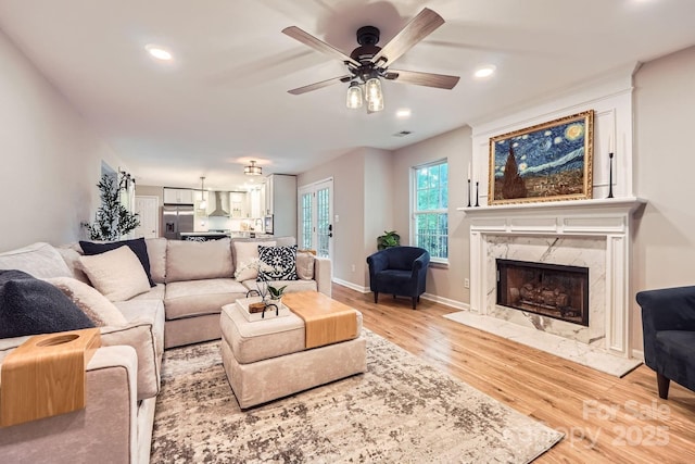 7810 Leisure Ln, Huntersville, NC 28078 - living area featuring a ceiling fan, light wood-style floors, a premium fireplace, and recessed lighting