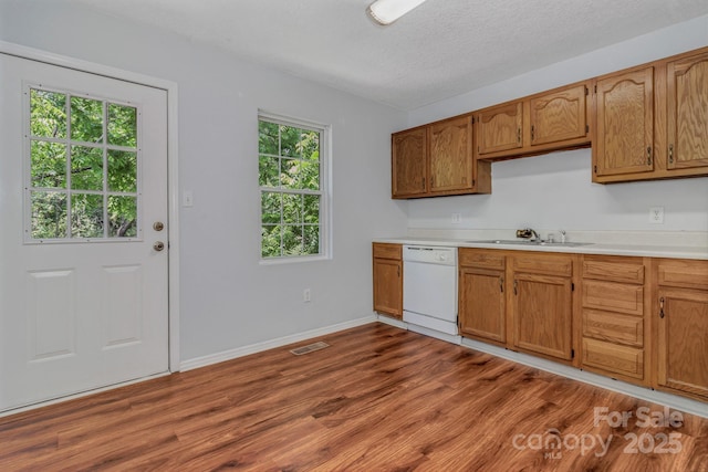 222 New Stock Rd, Weaverville, NC 28787 - kitchen with dishwasher, light countertops, dark wood-style flooring, brown cabinetry, and a textured ceiling