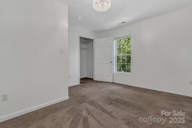 222 New Stock Rd, Weaverville, NC 28787 - unfurnished bedroom with carpet floors, a chandelier, and a closet