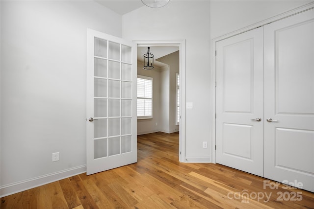 3008 Laney Pond Rd, Matthews, NC 28104 - unfurnished bedroom featuring light wood-type flooring, a closet, baseboards, and lofted ceiling