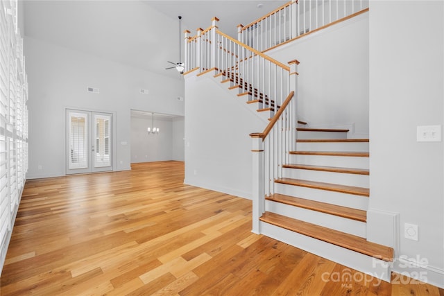 3008 Laney Pond Rd, Matthews, NC 28104 - staircase with a towering ceiling, wood finished floors, a chandelier, and baseboards