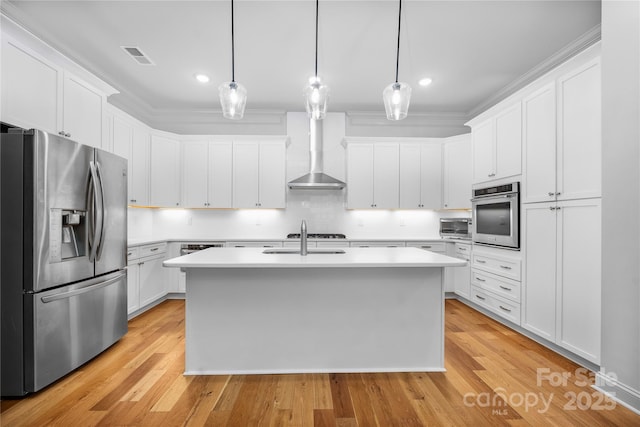 3008 Laney Pond Rd, Matthews, NC 28104 - kitchen with stainless steel appliances, wall chimney exhaust hood, light countertops, a kitchen island with sink, and recessed lighting