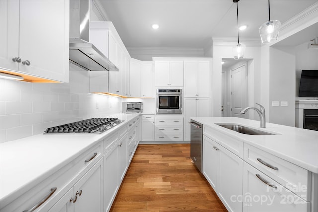3008 Laney Pond Rd, Matthews, NC 28104 - kitchen featuring wall chimney exhaust hood, a sink, appliances with stainless steel finishes, ornamental molding, and white cabinets