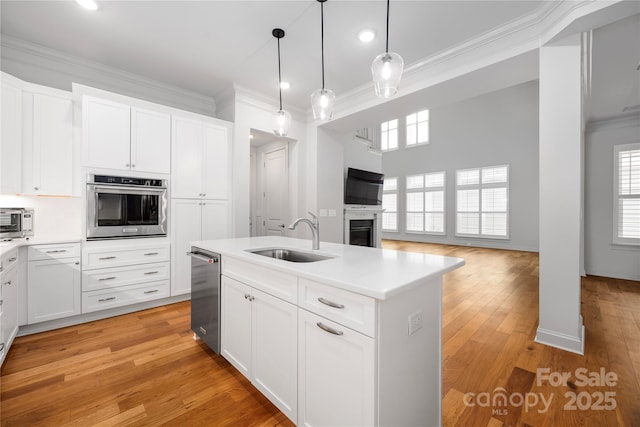 3008 Laney Pond Rd, Matthews, NC 28104 - kitchen with a sink, stainless steel appliances, crown molding, open floor plan, and light countertops