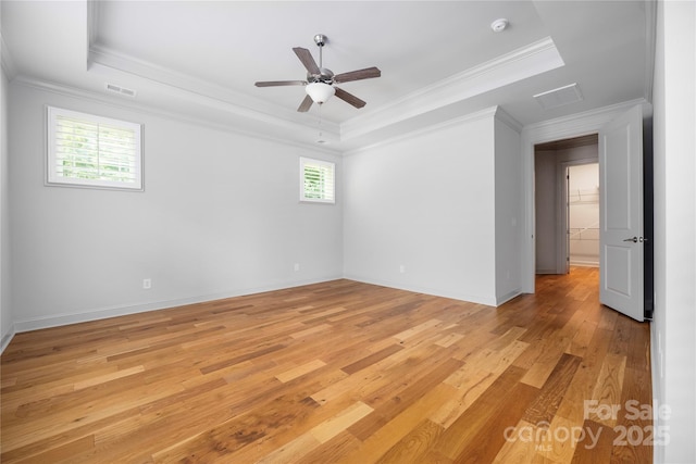 3008 Laney Pond Rd, Matthews, NC 28104 - spare room featuring a raised ceiling, light wood finished floors, crown molding, ceiling fan, and baseboards