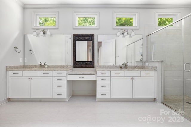 3008 Laney Pond Rd, Matthews, NC 28104 - full bathroom with two vanities, a shower stall, plenty of natural light, and crown molding