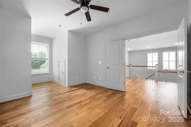 3008 Laney Pond Rd, Matthews, NC 28104 - spare room featuring light wood-type flooring, a ceiling fan, and baseboards