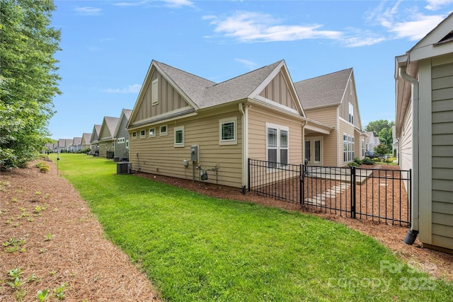 3008 Laney Pond Rd, Matthews, NC 28104 - view of home's exterior featuring board and batten siding, central AC unit, roof with shingles, and a residential view