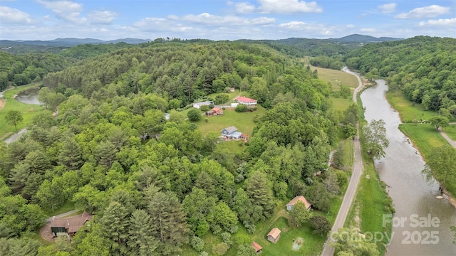 242 Ladd Parsons Rd, Crumpler, NC 28617 - aerial view of property's location with a heavily wooded area and a mountainous background