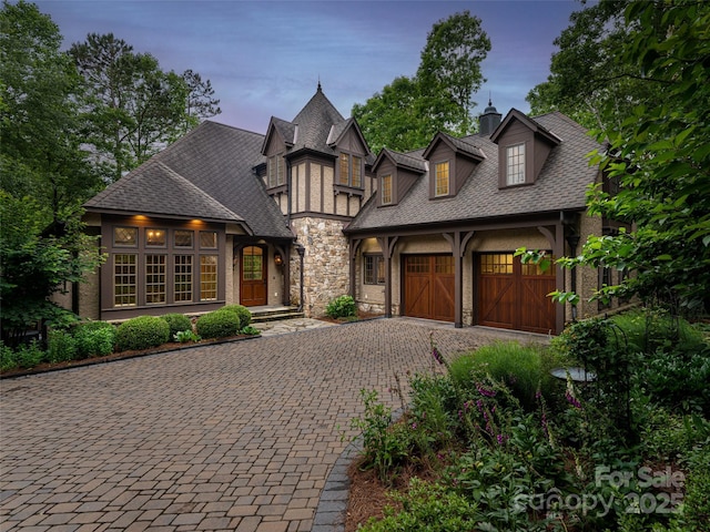 50 Brookline Dr, Asheville, NC 28803 - view of front of house with decorative driveway, an attached garage, stone siding, and a shingled roof