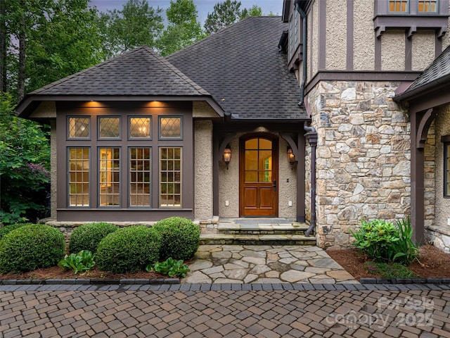 50 Brookline Dr, Asheville, NC 28803 - view of exterior entry with stone siding, stucco siding, and a shingled roof