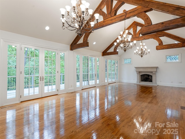 50 Brookline Dr, Asheville, NC 28803 - unfurnished living room with a chandelier, a premium fireplace, beamed ceiling, plenty of natural light, and high vaulted ceiling
