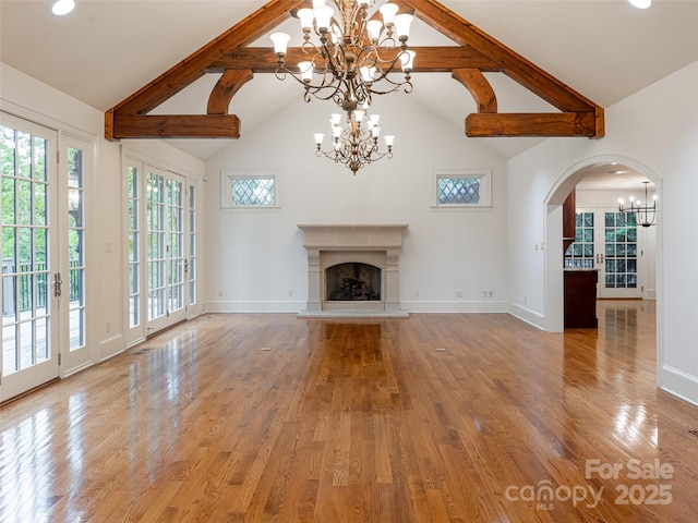 50 Brookline Dr, Asheville, NC 28803 - unfurnished living room with a chandelier, high vaulted ceiling, a fireplace with raised hearth, baseboards, and beam ceiling