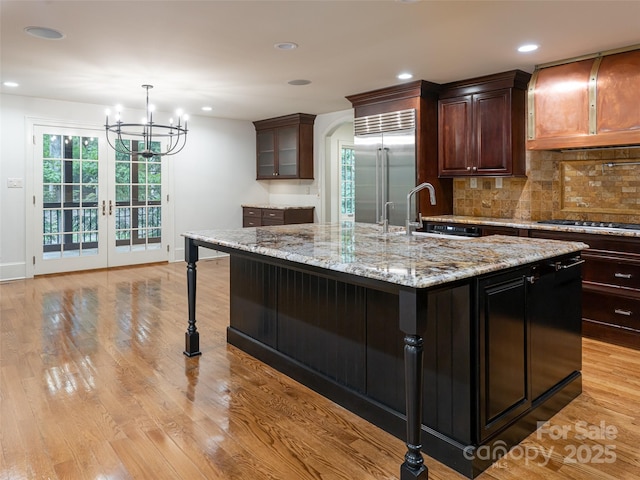50 Brookline Dr, Asheville, NC 28803 - kitchen with appliances with stainless steel finishes, a sink, decorative backsplash, a chandelier, and light stone countertops
