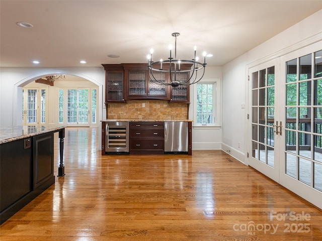 50 Brookline Dr, Asheville, NC 28803 - kitchen with beverage cooler, fridge, a chandelier, light wood finished floors, and dark brown cabinetry