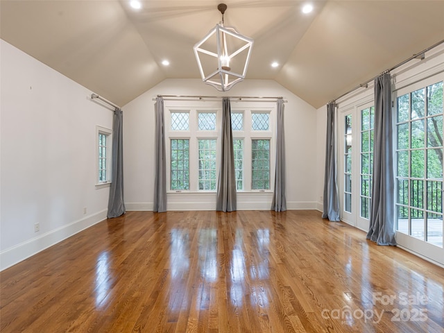 50 Brookline Dr, Asheville, NC 28803 - spare room with a chandelier, plenty of natural light, baseboards, wood finished floors, and lofted ceiling