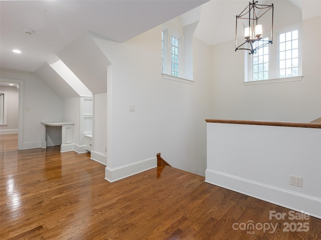 50 Brookline Dr, Asheville, NC 28803 - additional living space featuring vaulted ceiling, plenty of natural light, wood finished floors, a chandelier, and baseboards