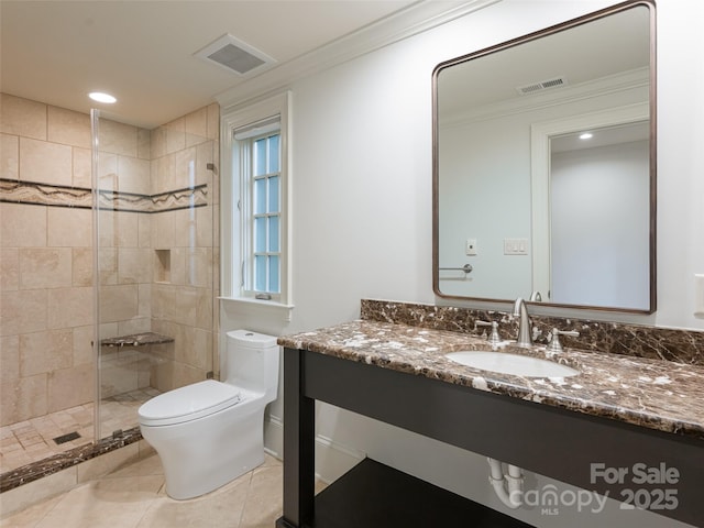 50 Brookline Dr, Asheville, NC 28803 - bathroom featuring toilet, crown molding, tiled shower, vanity, and tile patterned floors