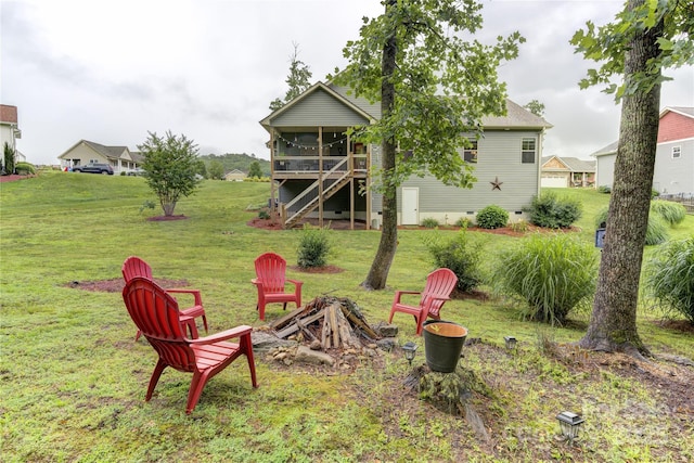 54 Asher Ln, Etowah, NC 28729 - view of green lawn with a sunroom and a fire pit