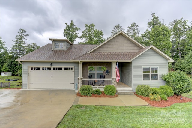 54 Asher Ln, Etowah, NC 28729 - view of front of property with a porch, a garage, a shingled roof, concrete driveway, and a front yard