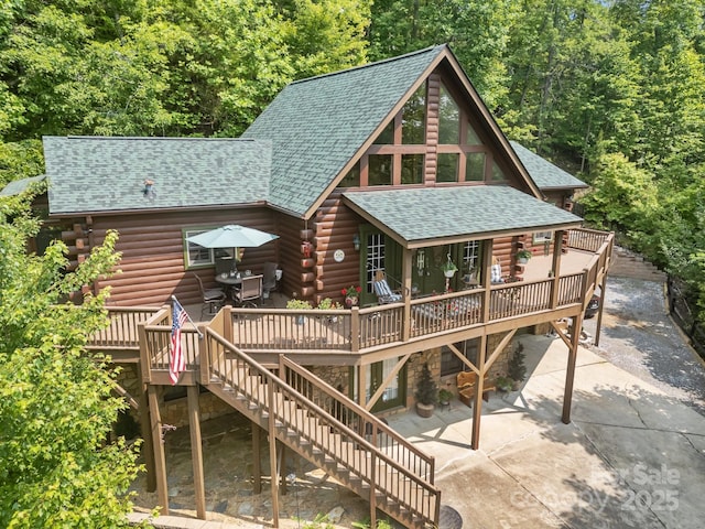 158 Raven Blvd, Lake Lure, NC 28746 - back of house with a shingled roof, a deck, stairs, log siding, and a patio area